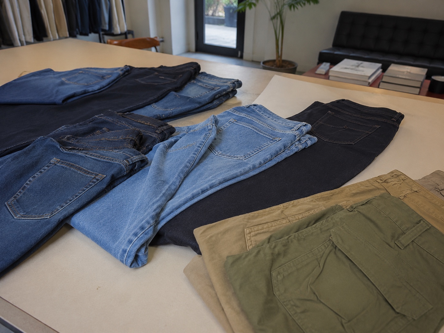 Garment samples and denim assortment on a worktable